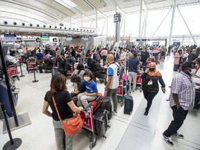 More travellers wait in line at Toronto Pearson Airport’s Terminal 1, May 9, 2022.
