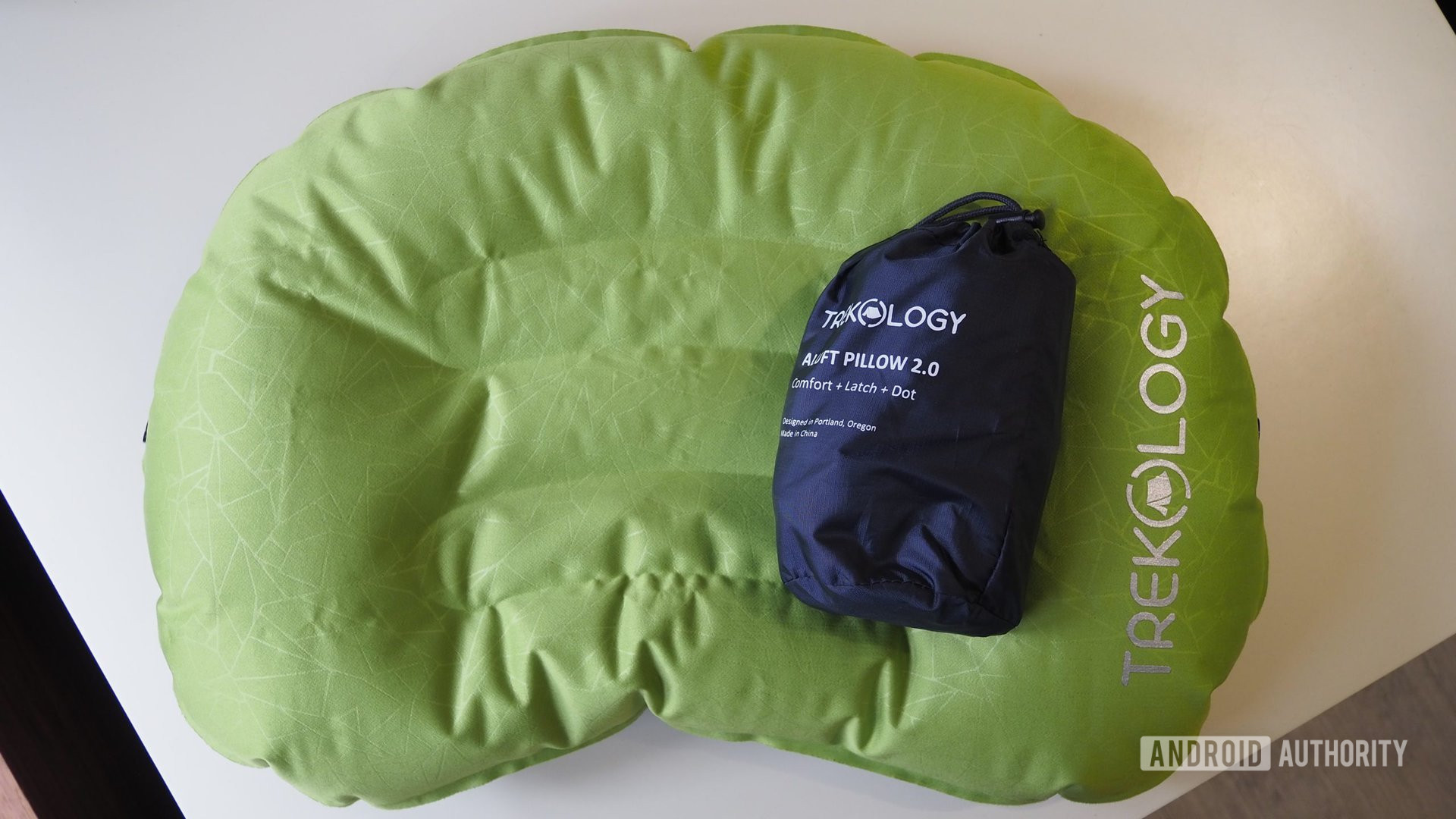 Two Trekology inflatable travel pillows, one is inflated, the other is deflated and in a carry bag